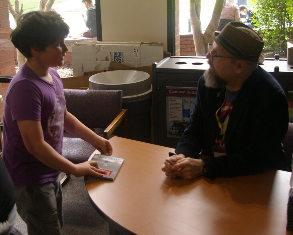 Alan Gratz book signing with a young student